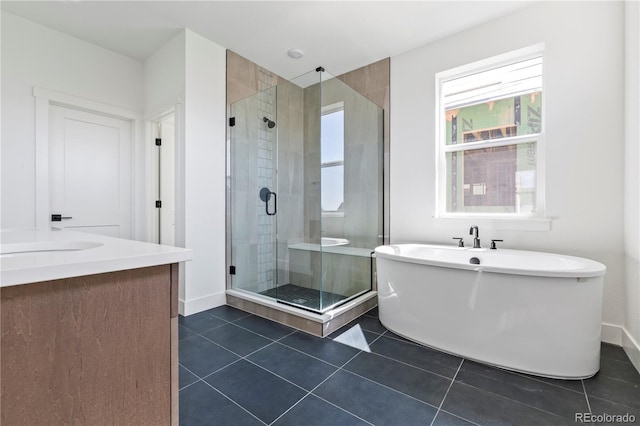 5626 W 142nd Ave, Broomfield, CO 80020 - bathroom featuring a shower stall, a freestanding tub, tile patterned flooring, and vanity
