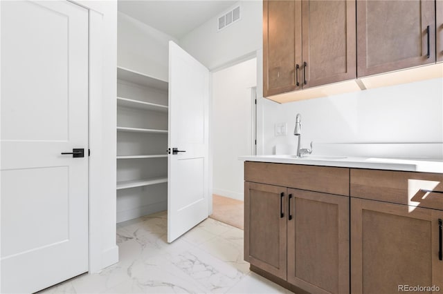5626 W 142nd Ave, Broomfield, CO 80020 - laundry area with light marble finish floors and a sink