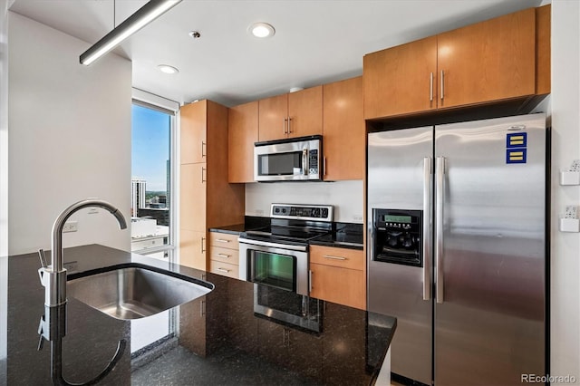 891 14th St Unit 2105, Denver, CO 80202 - kitchen featuring appliances with stainless steel finishes, recessed lighting, dark stone counters, and brown cabinets