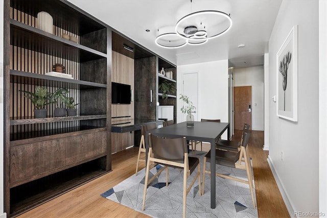 891 14th St Unit 2105, Denver, CO 80202 - dining room featuring wood finished floors and a chandelier
