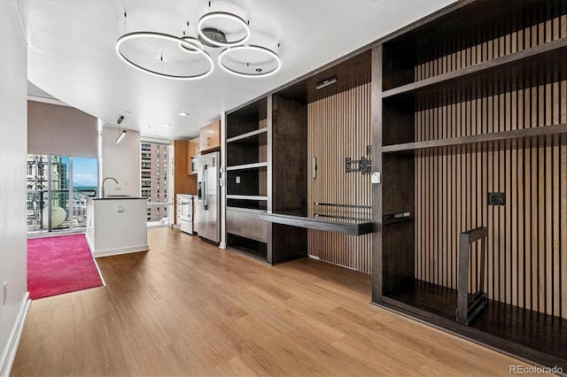 891 14th St Unit 2105, Denver, CO 80202 - unfurnished living room featuring wood finished floors and recessed lighting
