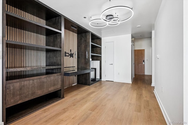 891 14th St Unit 2105, Denver, CO 80202 - unfurnished living room featuring wood finished floors, a chandelier, and built in features