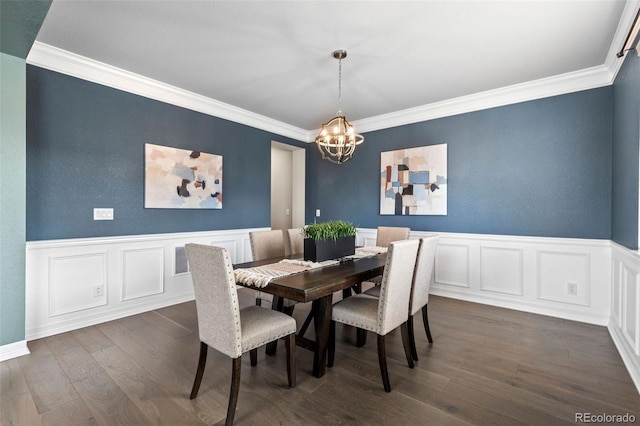11522 Trona Ct, Parker, CO 80138 - dining area featuring a chandelier, ornamental molding, a decorative wall, dark wood-style flooring, and a wainscoted wall