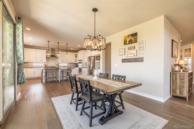 11522 Trona Ct, Parker, CO 80138 - dining area featuring recessed lighting, dark wood finished floors, a chandelier, and baseboards