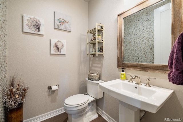 11522 Trona Ct, Parker, CO 80138 - bathroom featuring toilet, baseboards, and a sink