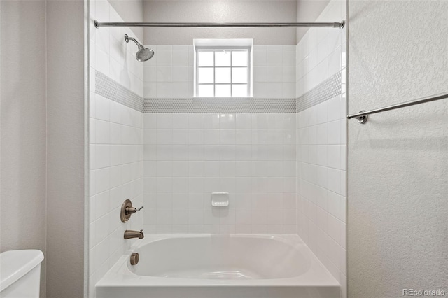 11522 Trona Ct, Parker, CO 80138 - full bath featuring toilet, a textured wall, and bathtub / shower combination