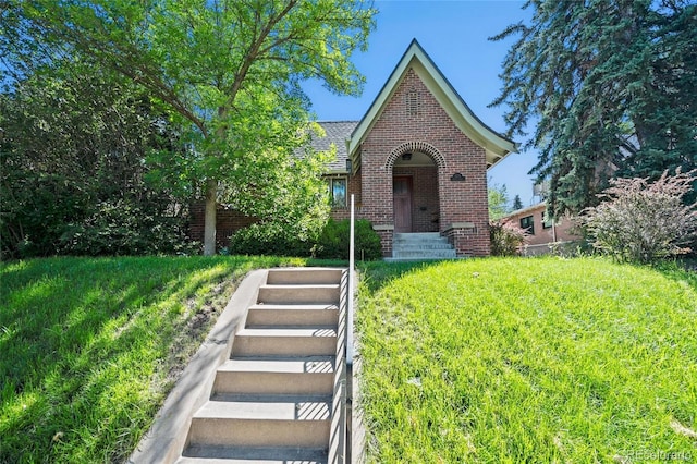 english style home featuring brick siding