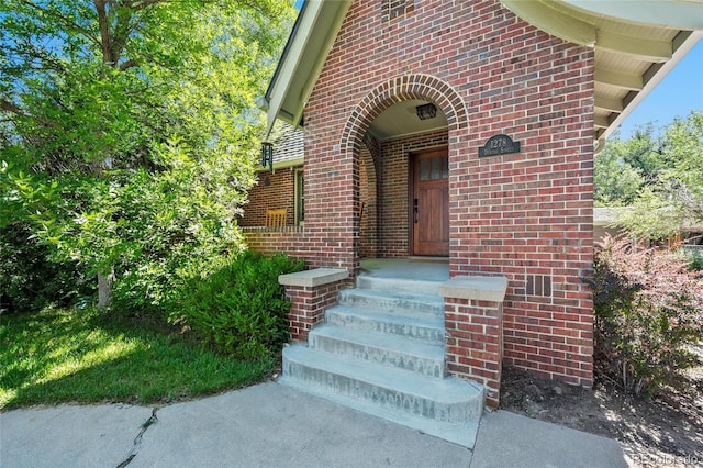 property entrance featuring brick siding