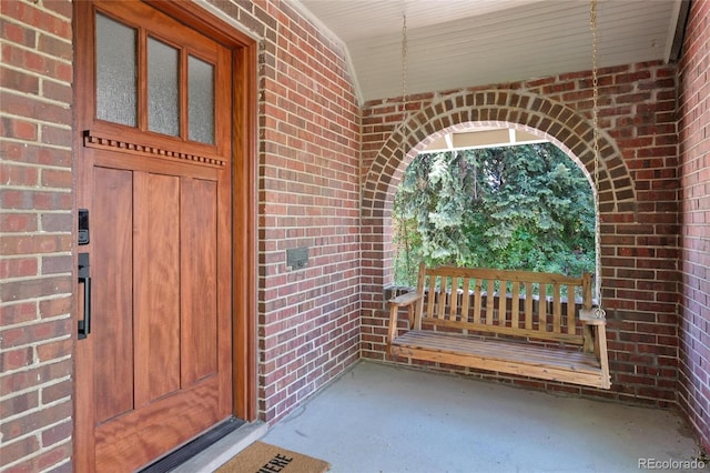 entrance to property featuring brick siding