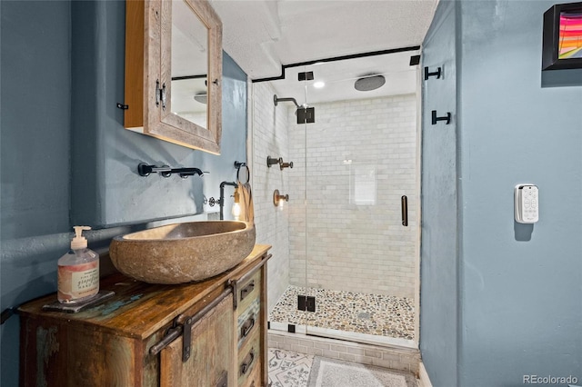 bathroom with a stall shower, vanity, and tile patterned flooring