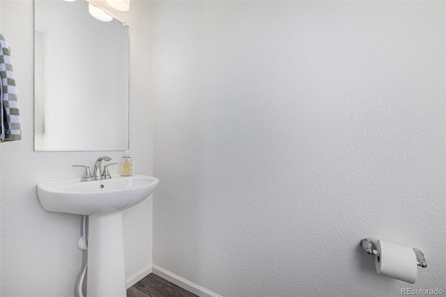 bathroom with hardwood / wood-style floors