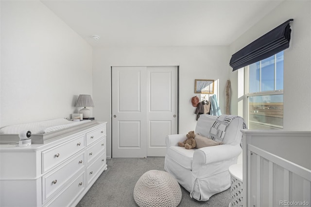 bedroom featuring light carpet and a closet