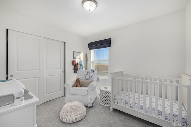 carpeted bedroom featuring a closet and a nursery area