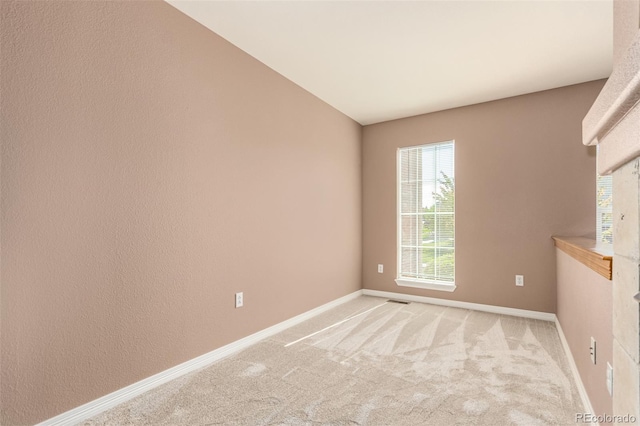 unfurnished room with light carpet