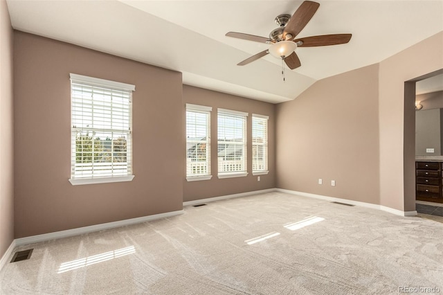 carpeted empty room featuring ceiling fan and vaulted ceiling