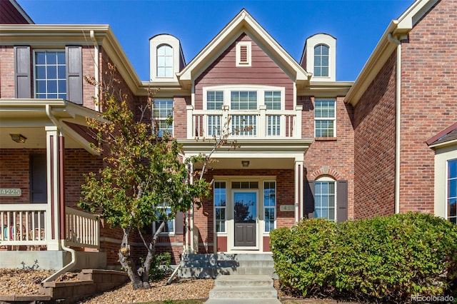 view of front of property with brick siding and a porch