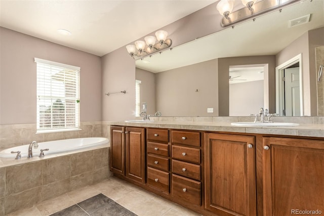 bathroom featuring tiled tub, tile patterned flooring, vanity, and ceiling fan