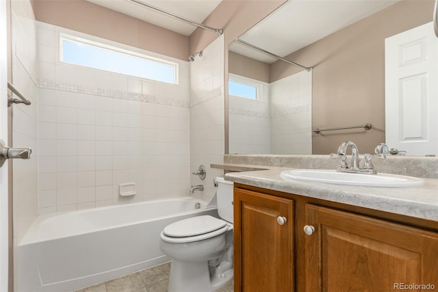 full bathroom featuring tiled shower / bath combo, tile patterned floors, vanity, and toilet