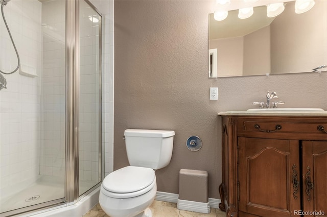 bathroom with vanity, toilet, a shower with door, and tile patterned floors