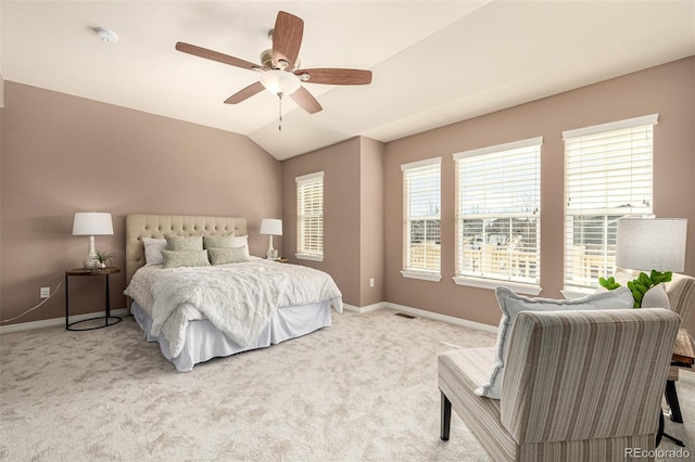 carpeted bedroom with lofted ceiling, visible vents, a ceiling fan, and baseboards