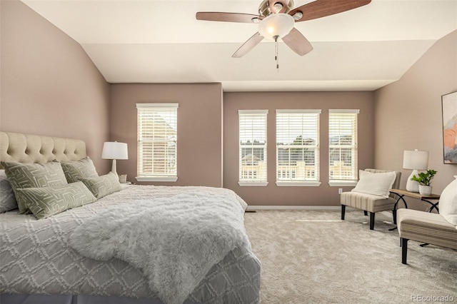 carpeted bedroom with lofted ceiling, ceiling fan, and baseboards