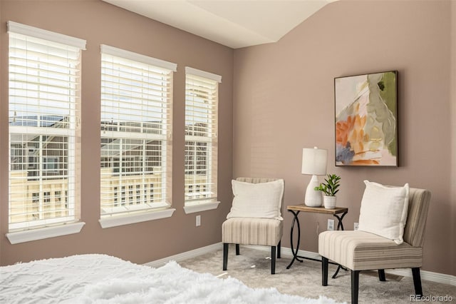 carpeted bedroom with lofted ceiling, multiple windows, and baseboards