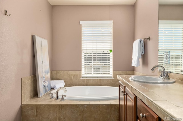 full bathroom featuring vanity and a bath