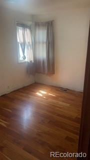 160 Utica St, Denver, CO 80219 - spare room featuring wood finished floors
