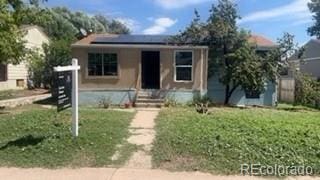 160 Utica St, Denver, CO 80219 - bungalow with a front yard, stucco siding, and solar panels