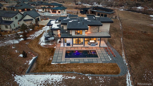 snowy aerial view featuring a residential view