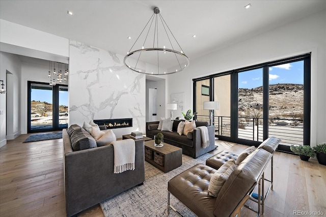 living area with a fireplace, hardwood / wood-style flooring, and a healthy amount of sunlight