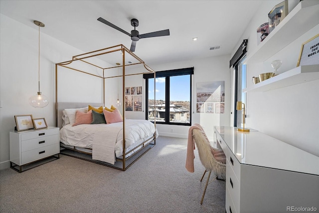 carpeted bedroom featuring baseboards and visible vents