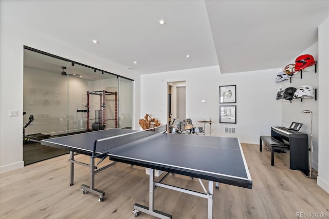 recreation room featuring baseboards, light wood finished floors, visible vents, and recessed lighting