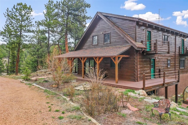 view of home's exterior with a wooden deck and a balcony