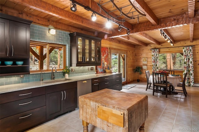 kitchen featuring track lighting, beam ceiling, a sink, wooden ceiling, and light tile patterned floors