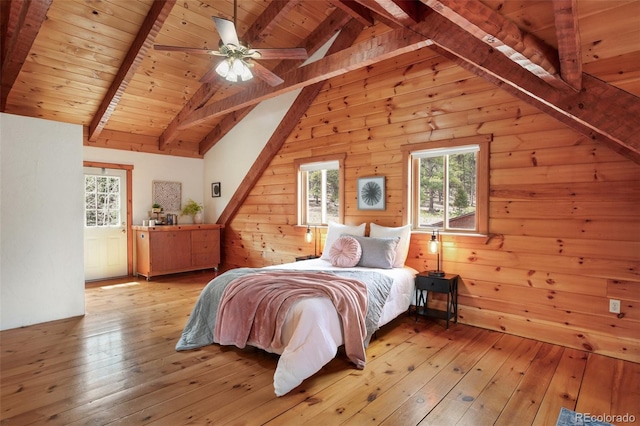 bedroom featuring vaulted ceiling with beams, wood walls, light wood-style flooring, and wood ceiling