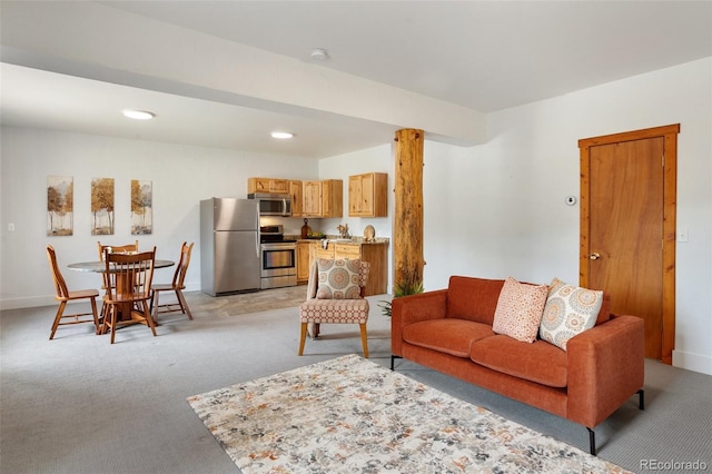 living room with baseboards and light carpet