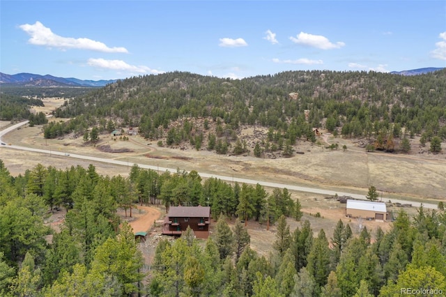 drone / aerial view with a mountain view and a wooded view