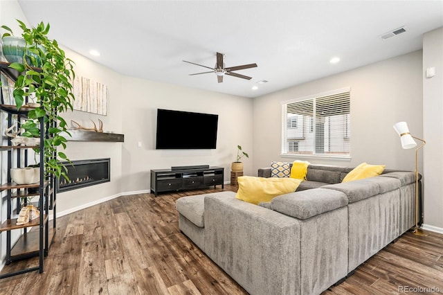 18077 E 99th Ave, Commerce City, CO 80022 - living room featuring ceiling fan, wood finished floors, a glass covered fireplace, baseboards, and recessed lighting