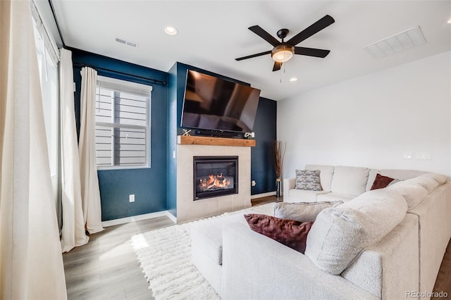 8517 Eckley St, Littleton, CO 80125 - living room with a ceiling fan, wood finished floors, a fireplace, baseboards, and recessed lighting
