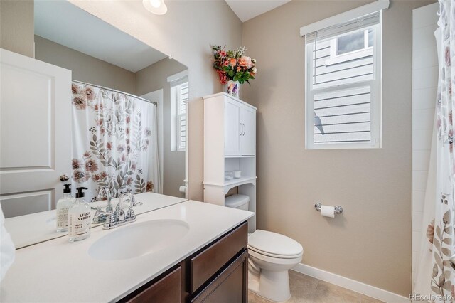 8517 Eckley St, Littleton, CO 80125 - bathroom with toilet, vanity, baseboards, and a shower with shower curtain