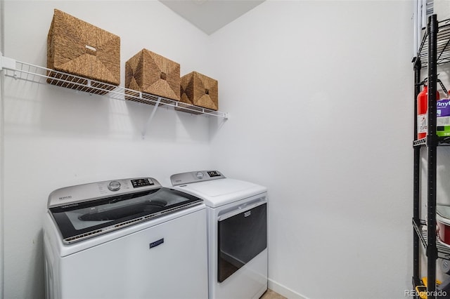 8517 Eckley St, Littleton, CO 80125 - laundry room featuring washing machine and dryer and baseboards