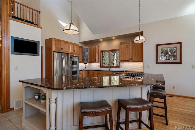 kitchen with visible vents, appliances with stainless steel finishes, open shelves, tasteful backsplash, and brown cabinetry