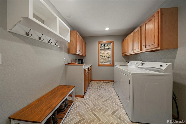 washroom featuring separate washer and dryer, recessed lighting, cabinet space, and baseboards