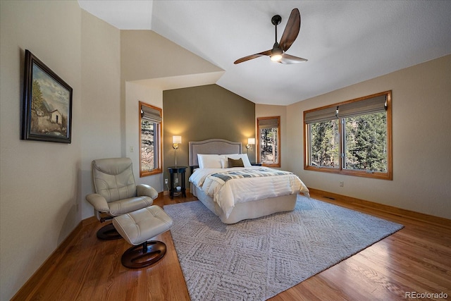 bedroom featuring a ceiling fan, vaulted ceiling, and wood finished floors