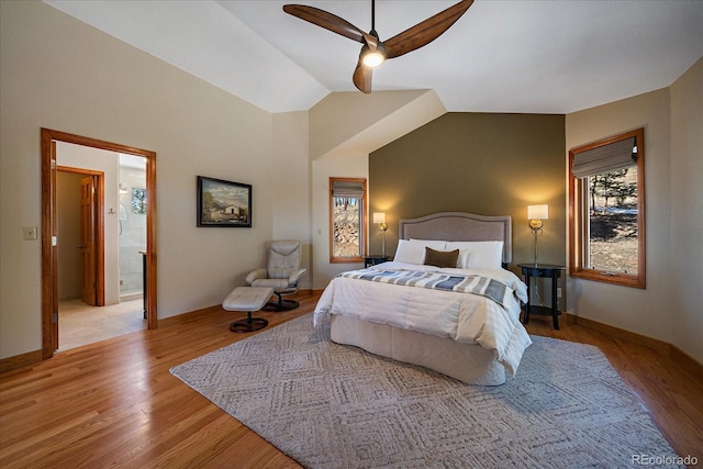 bedroom featuring vaulted ceiling, light wood-style flooring, and baseboards