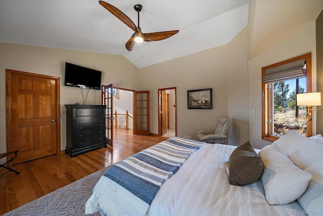 bedroom featuring lofted ceiling, access to outside, wood finished floors, and a ceiling fan