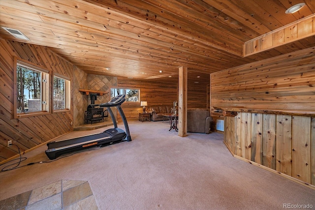 workout area with wood ceiling, wood walls, and carpet