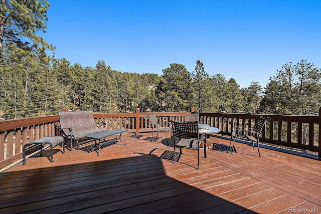 wooden deck with a view of trees