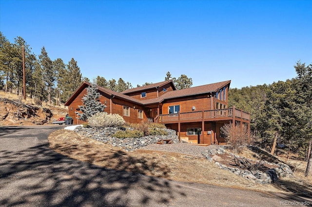 exterior space with driveway and a deck